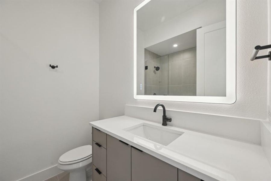 Bathroom with vanity, toilet, and walk in shower