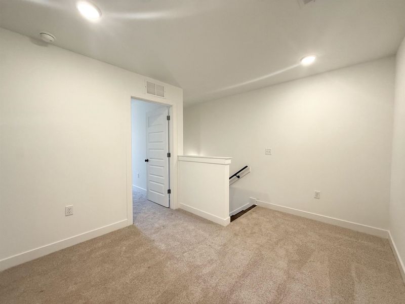 Unfurnished room featuring light carpet and recessed lighting