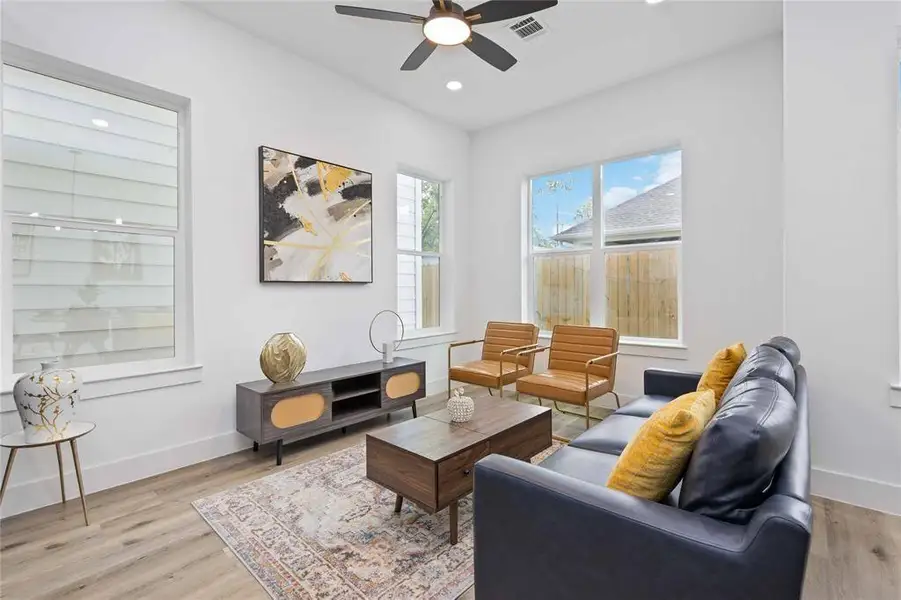 Large windows bring in natural light that make this living space a joy to relax in! Upgraded floors add to the modern and light feel to the new home.