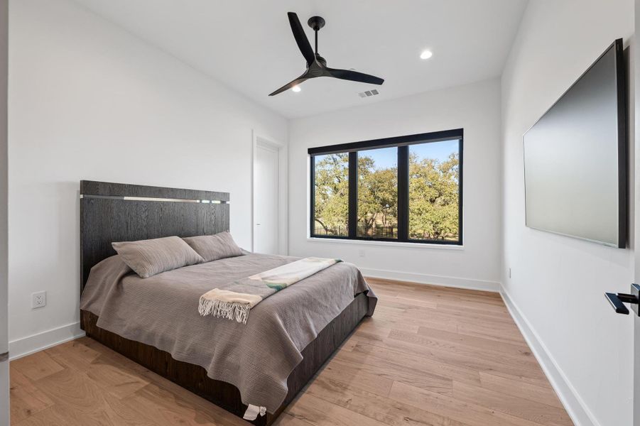 Bedroom featuring a ceiling fan, light wood-style flooring, baseboards, visible vents, and recessed lighting Bedroom featuring a ceiling fan, light wood-style flooring, baseboards, visible vents, and recessed lighting