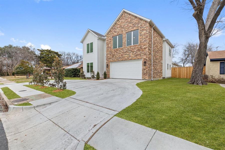 The home also includes a two-car garage with a horseshoe driveway