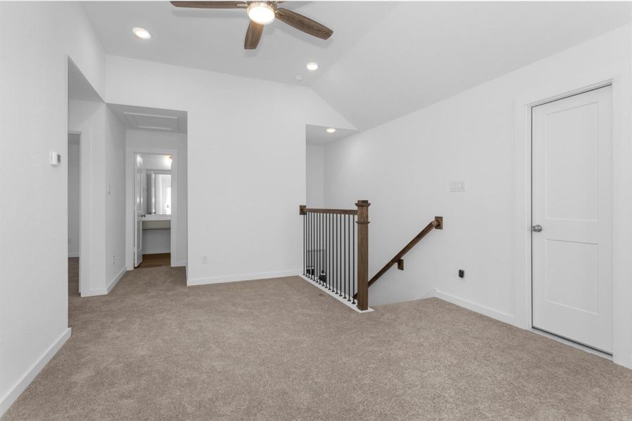 This additional view of the upstairs game room highlights its open layout, and convenient access to nearby bedrooms and bathrooms.