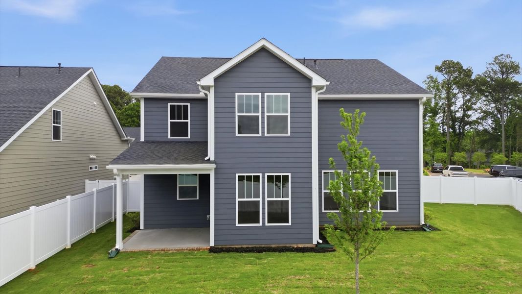 Exceptional outdoor living begins with a covered back porch in this thoughtfully designed home located in Greenville, SC