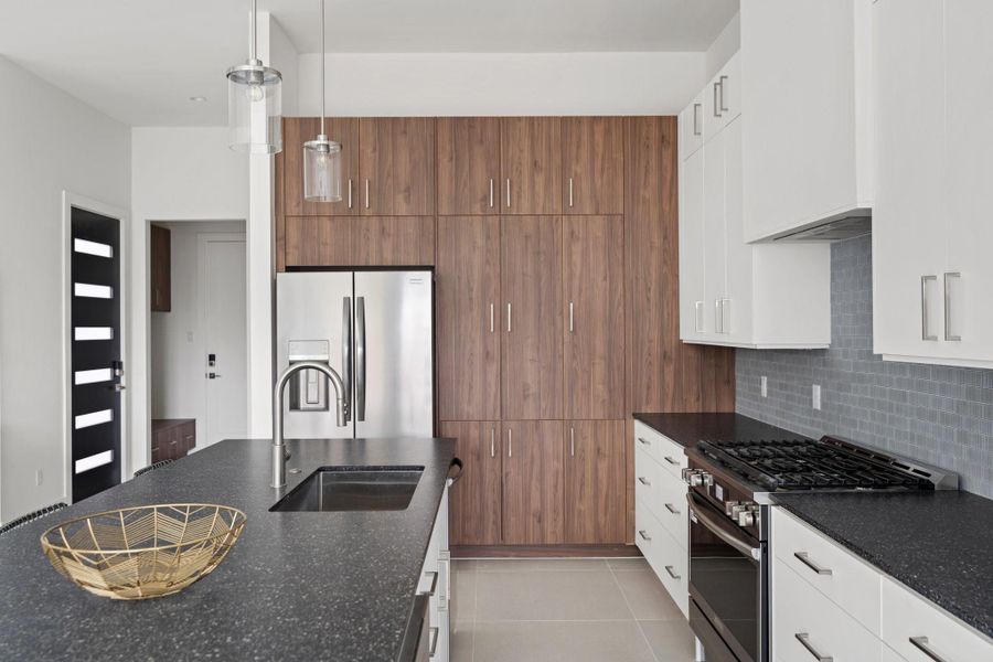 Gourmet chef's kitchen epitomizes functional luxury with a custom appliance garage, generous storage solutions, and sophisticated design elements. The adjacent walk-in pantry enhances convenience and organization. Gourmet chef's kitchen epitomizes functional luxury with a custom appliance garage, generous storage solutions, and sophisticated design elements. The adjacent walk-in pantry enhances convenience and organization.