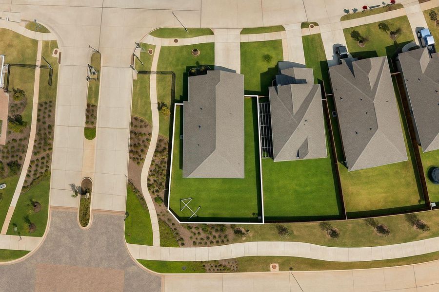 This sweeping aerial shot highlights the spacious lot with no back neighbors and brick privacy fence! This home sits in a gated secion of Sunterra, offering plenty of privacy.