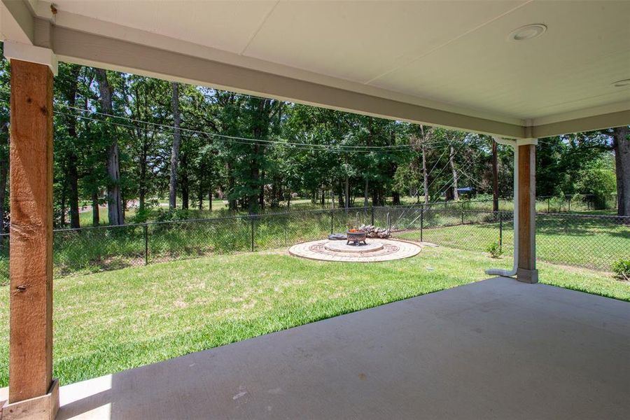 View of yard featuring a patio area and view of scattered trees View of yard featuring a patio area and view of scattered trees