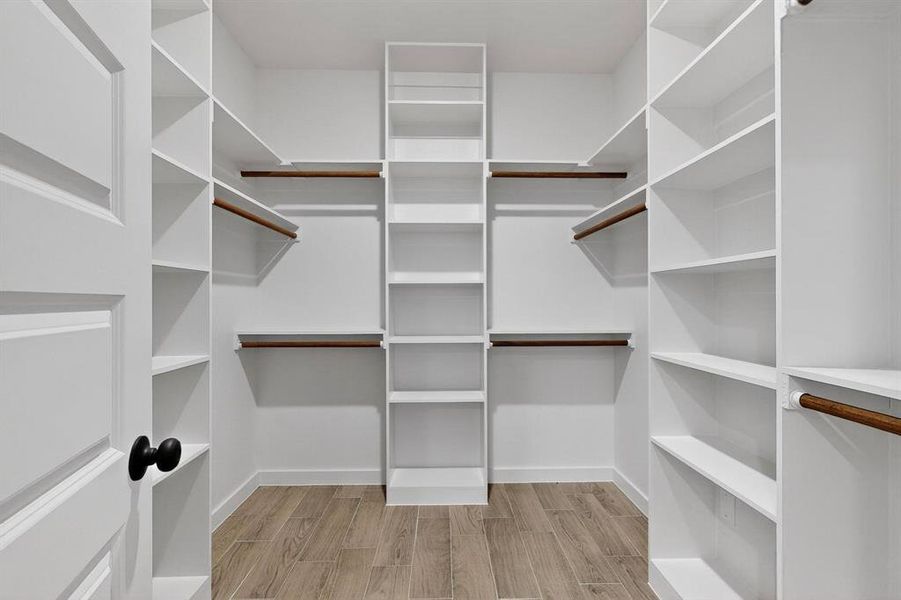 Spacious closet featuring wood tiled floors Spacious closet featuring wood tiled floors
