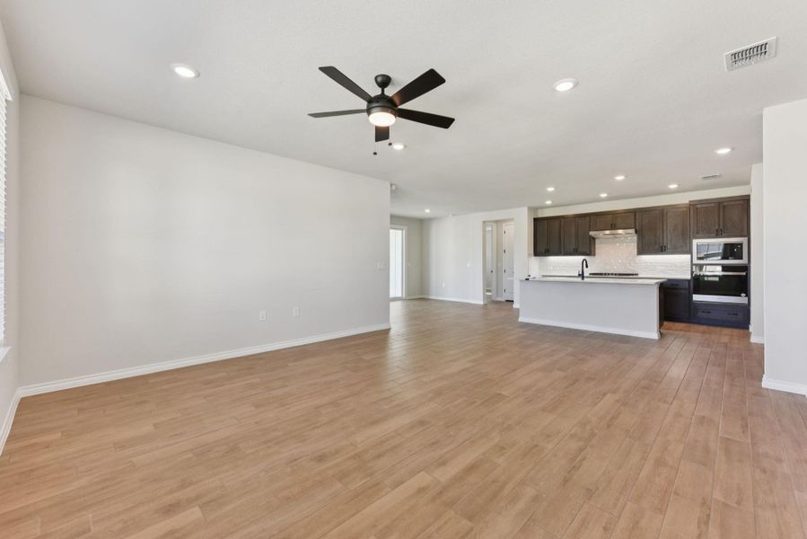 Unfurnished living room with recessed lighting, a ceiling fan, and light wood finished floors