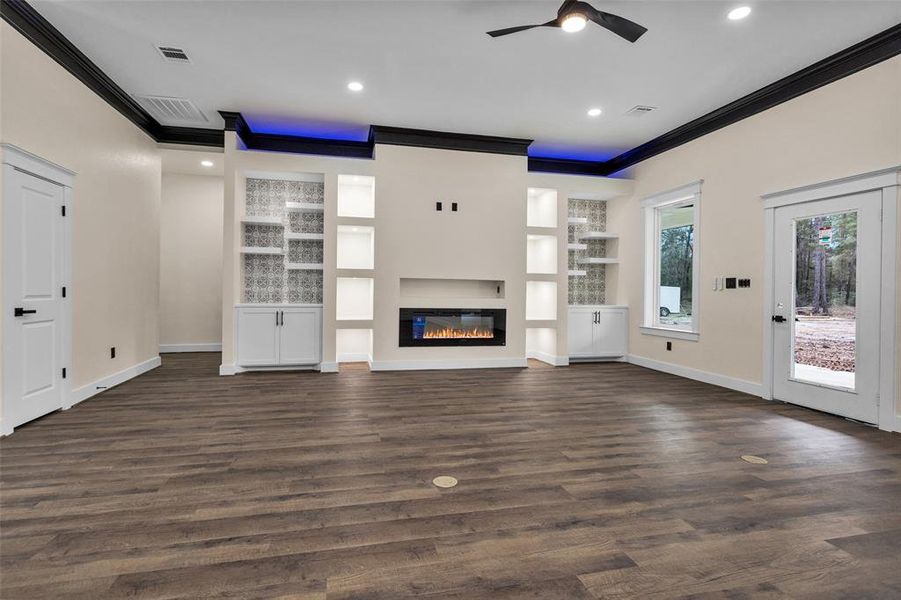 This is the living room showcasing the entire back wall of lighted built ins. Absolutely stunning in person!