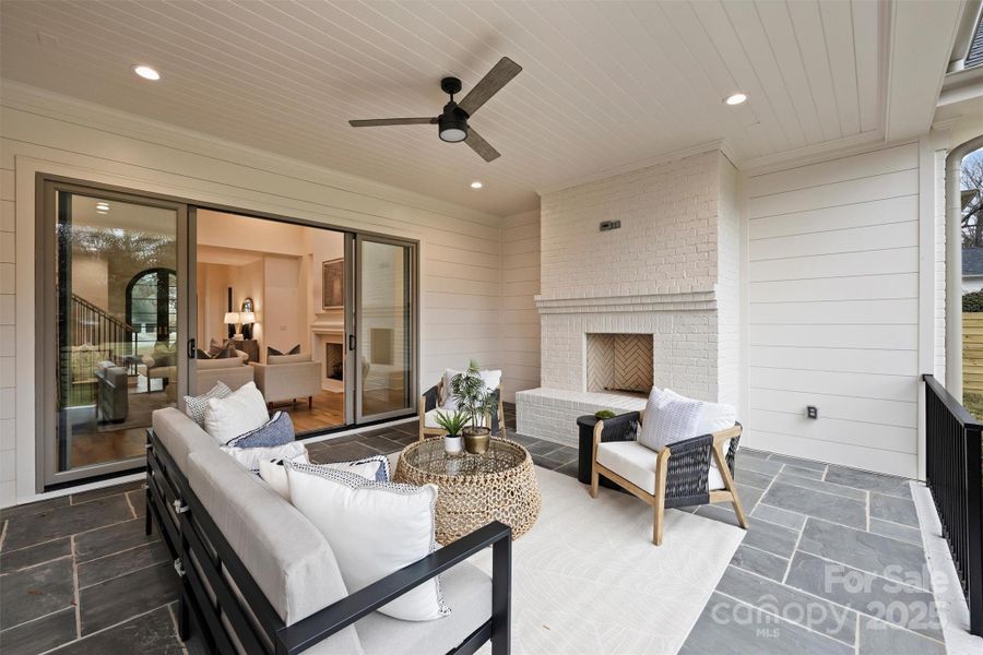 Step outside to discover the covered porch complete with a wood-burning fireplace, ideal for entertaining guests and enjoying football games in the Fall!