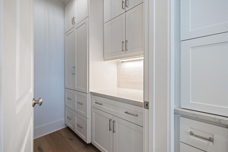View of Pantry. Additional shelving behind door.