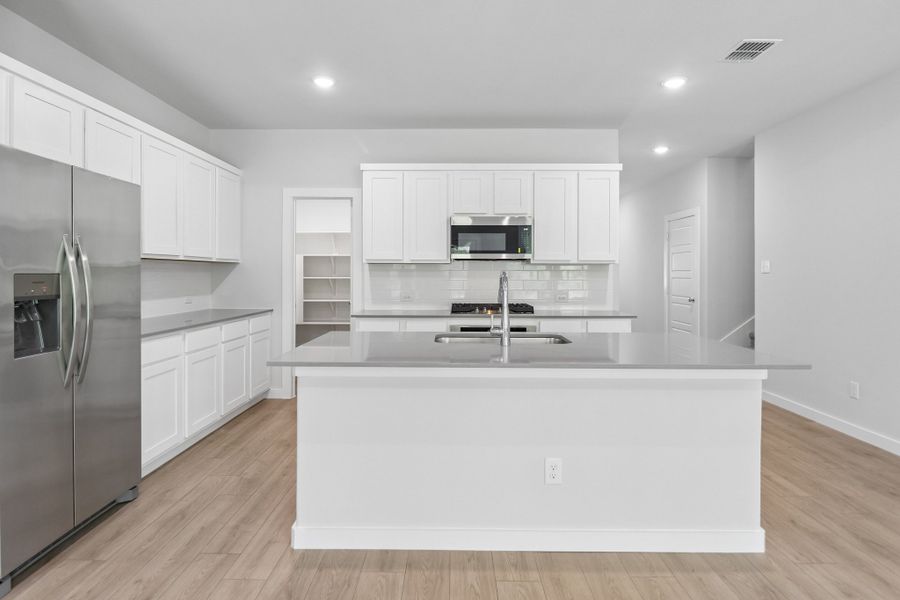 Kitchen in the Masters home plan by Trophy Signature Homes