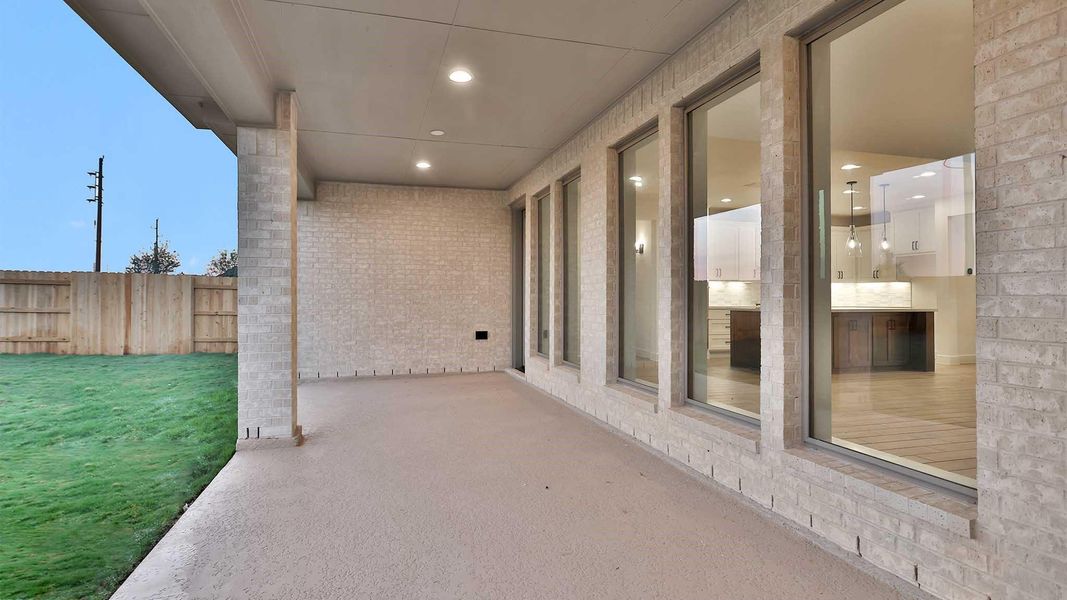 Exterior details and patio area of a home in Elyson 65', Katy (Image 2).