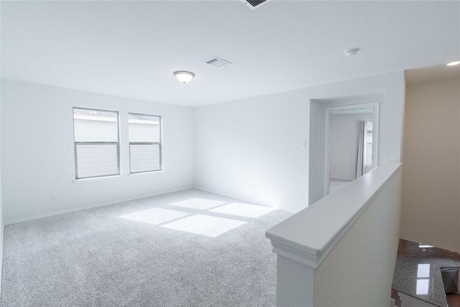 A versatile open loft area provides additional living space with abundant natural illumination. A versatile open loft area provides additional living space with abundant natural illumination.