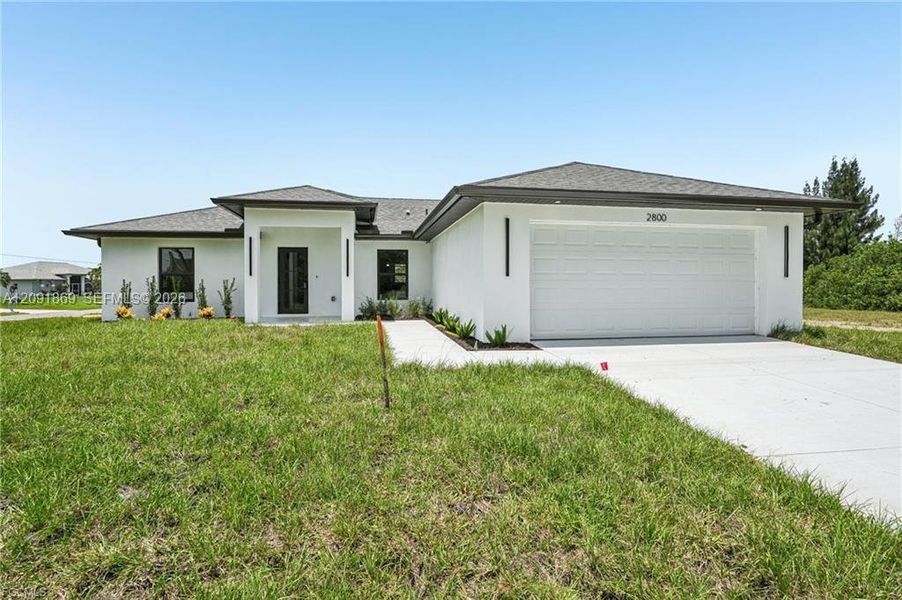 Front exterior of a new home in , Cape Coral, FL, highlighting curb appeal (Image 23). Front exterior of a new home in , Cape Coral, FL, highlighting curb appeal (Image 23).
