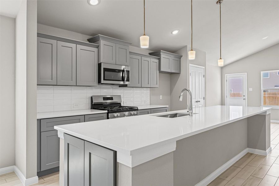 Smooth stone countertops and classic cabinetry anchor this modern, light-filled workspace. Smooth stone countertops and classic cabinetry anchor this modern, light-filled workspace.