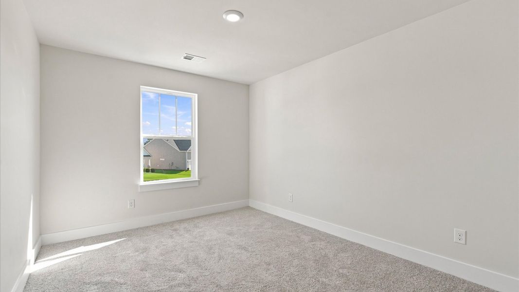 First-class bedroom with generous proportions, a walk-in closet, and beautiful natural light through large windows