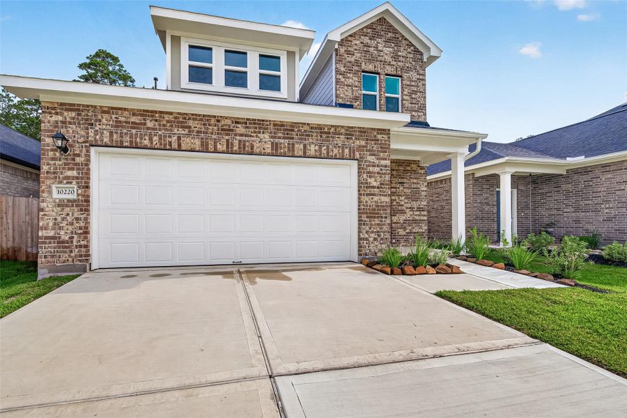 Front exterior of a new home in Mill Creek Trails, Magnolia, TX, highlighting curb appeal (Image 26).