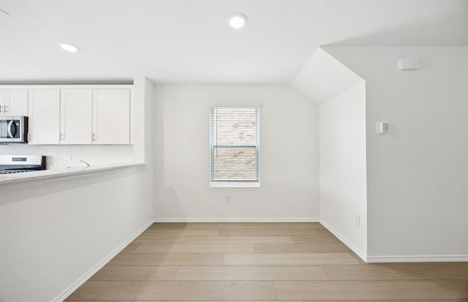 Dining nook off kitchen with large windows