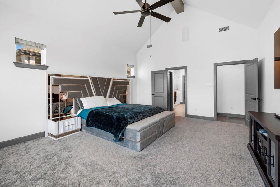Luxurious primary retreat with vaulted ceilings and generous space for comfort and style.
