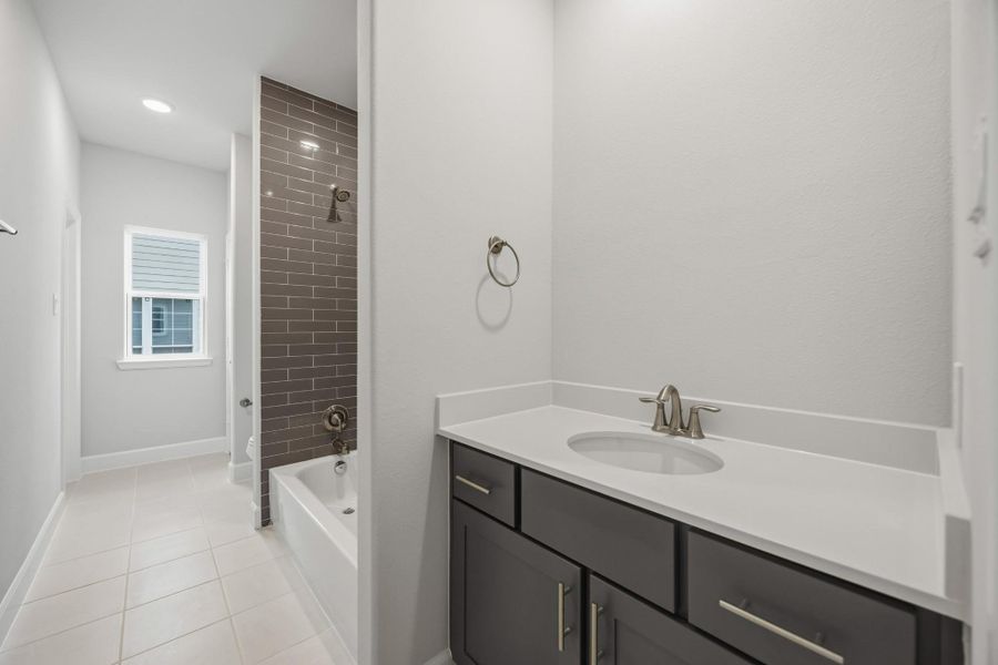 Flooded with light and finished with care, this hall bath delivers both function and finesse. Bonus points for that deep tub and elevated tilework. Flooded with light and finished with care, this hall bath delivers both function and finesse. Bonus points for that deep tub and elevated tilework.
