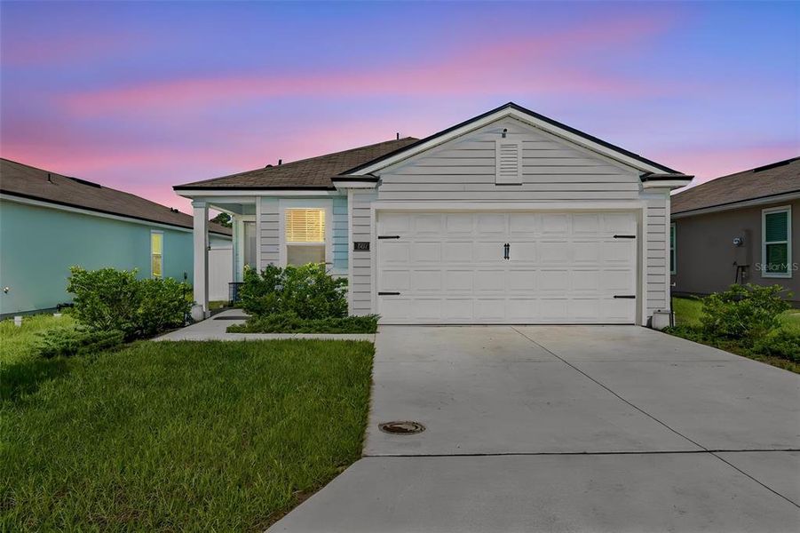 Front exterior of a new home in Ravenswood Village, St. Augustine, FL, highlighting curb appeal (Image 1). Front exterior of a new home in Ravenswood Village, St. Augustine, FL, highlighting curb appeal (Image 1).