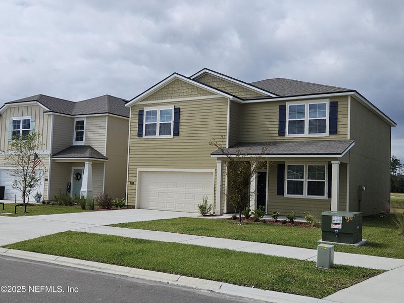 Front exterior of a new home in The Arbors, Jacksonville, FL, highlighting curb appeal (Image 19).