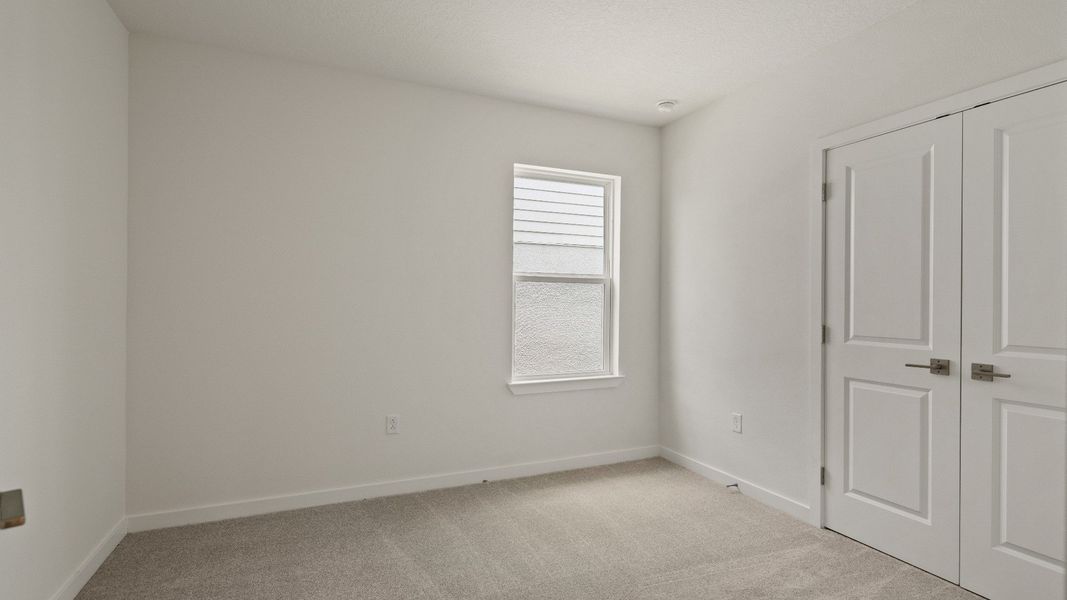 Flexible room perfect for a home office, guest space, or playroom—complete with closet and natural light