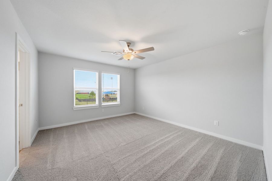 A room with a ceiling fan and a window. A room with a ceiling fan and a window.