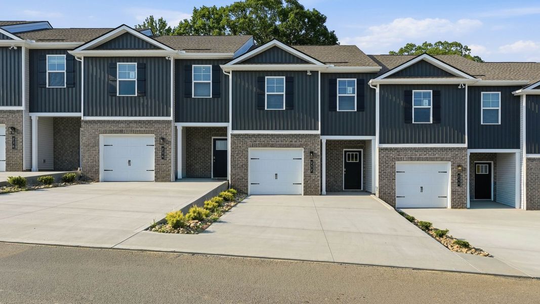 Front exterior of a new home in Macon Townhomes, Seymour, TN, highlighting curb appeal (Image 1). Front exterior of a new home in Macon Townhomes, Seymour, TN, highlighting curb appeal (Image 1).