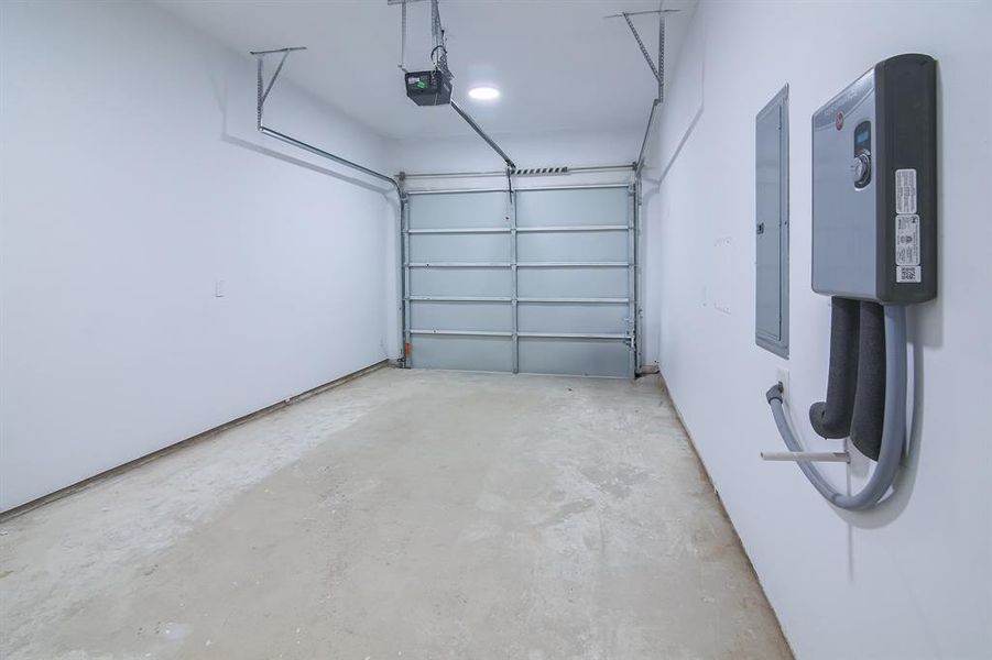 Garage with a garage door opener and electric panel