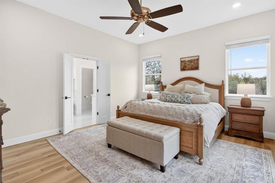 Bedroom with light wood-type flooring, ceiling fan, and recessed lighting Bedroom with light wood-type flooring, ceiling fan, and recessed lighting