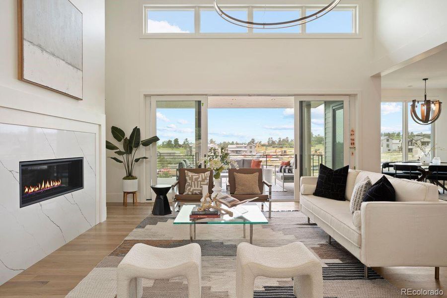 Expansive sliding glass doors paired with clerestory windows above maximize natural light and showcase the scenic outdoor setting.