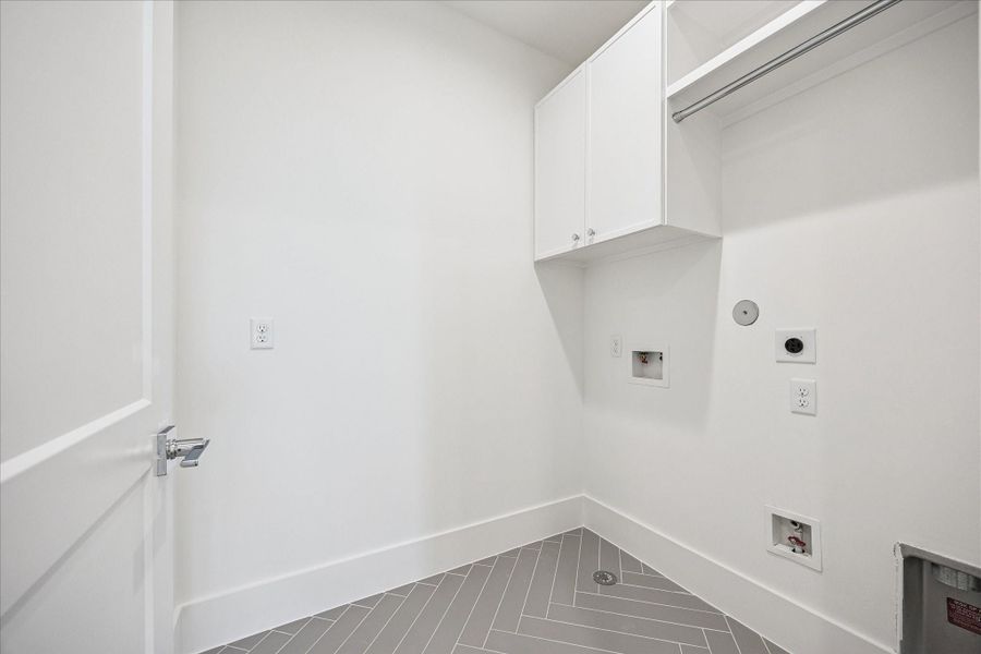 Convenient oversized utility room with extra storage.