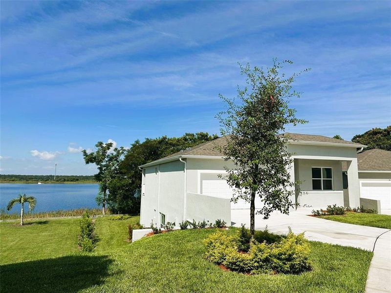 Front exterior of a new home in , Haines City, FL, highlighting curb appeal (Image 25). Front exterior of a new home in , Haines City, FL, highlighting curb appeal (Image 25).