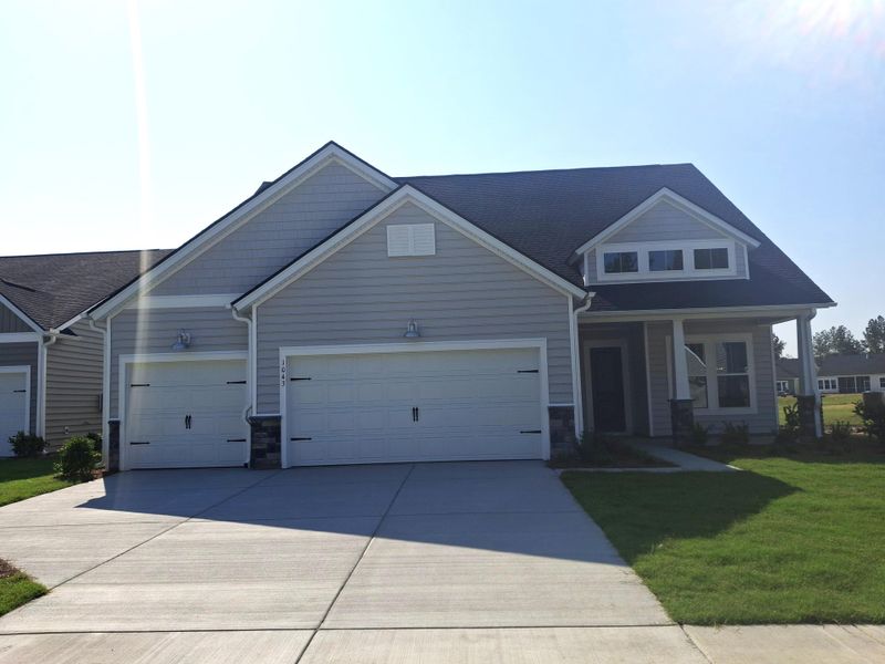 Front exterior of a new home in Horizons at Summers Corner | 55+, Summerville, SC, highlighting curb appeal (Image 26).