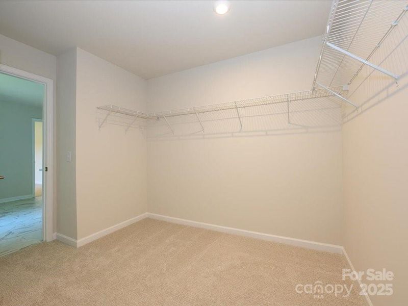 A huge walk-in closet is the finishing touch in this primary suite. A huge walk-in closet is the finishing touch in this primary suite.