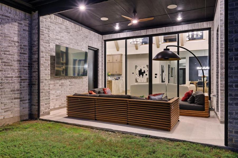 Fenced backyard with a patio area, an outdoor living space, and ceiling fan with electric shades that come down with the push of a button Fenced backyard with a patio area, an outdoor living space, and ceiling fan with electric shades that come down with the push of a button