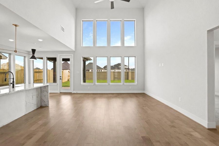 **REPRESENTATION PHOTO OF THE SAME PLAN, FINISHES WILL VARY** This stunning family room features soaring high floor to ceiling windows that bring in abundant natural light! **REPRESENTATION PHOTO OF THE SAME PLAN, FINISHES WILL VARY** This stunning family room features soaring high floor to ceiling windows that bring in abundant natural light!
