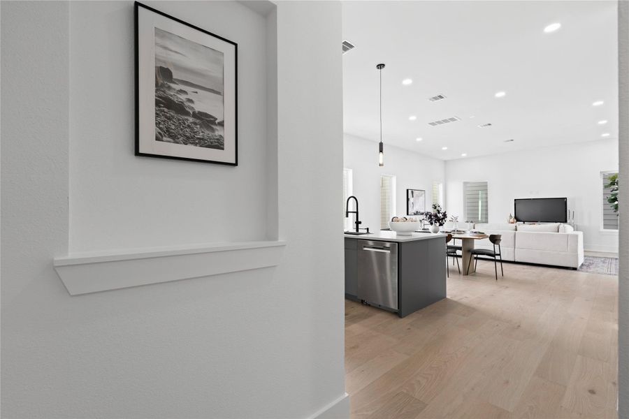 A composed reveal into the heart of the home, where soft sightlines and warm flooring draw you toward light-filled living spaces. Thoughtful framing turns everyday circulation into a moment of calm.