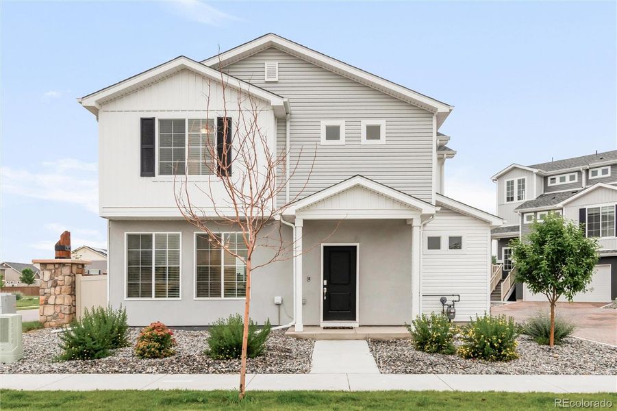 Front exterior of a new home in Thompson River Ranch, Johnstown, CO, highlighting curb appeal (Image 2).