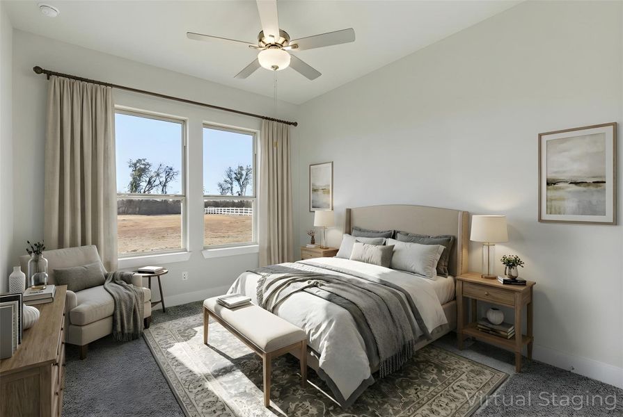 Carpeted bedroom featuring baseboards and ceiling fan