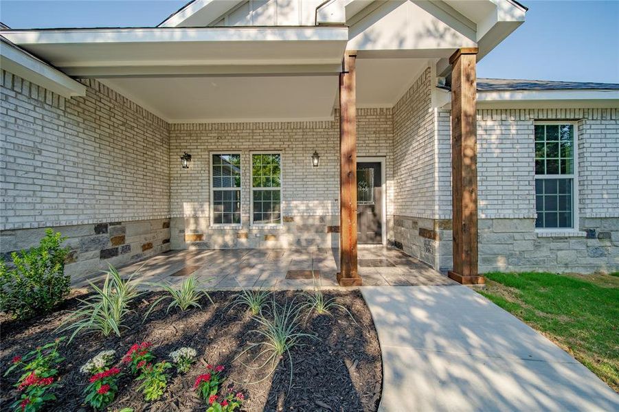 Doorway to property featuring a patio