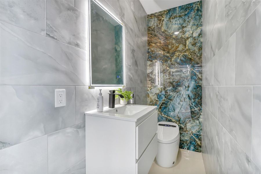 A stylish half bath provides convenience for guests without interrupting private spaces. Clean design and a well placed vanity make it feel intentional.