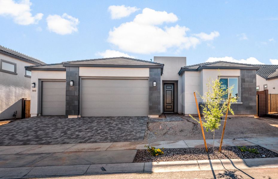 Front exterior of a new home in Artisan at Asante, Surprise, AZ, highlighting curb appeal (Image 2). Front exterior of a new home in Artisan at Asante, Surprise, AZ, highlighting curb appeal (Image 2).