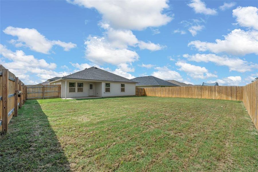 Rear view of house with a fenced backyard Rear view of house with a fenced backyard