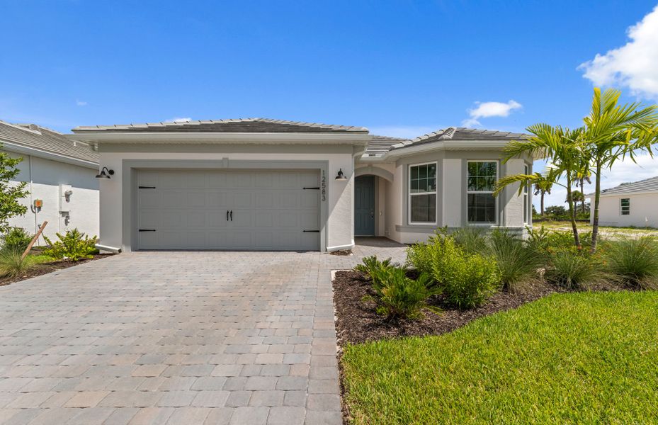 Front exterior of a new home in TerraWalk at Babcock Ranch, Alva, FL, highlighting curb appeal (Image 1). Front exterior of a new home in TerraWalk at Babcock Ranch, Alva, FL, highlighting curb appeal (Image 1).
