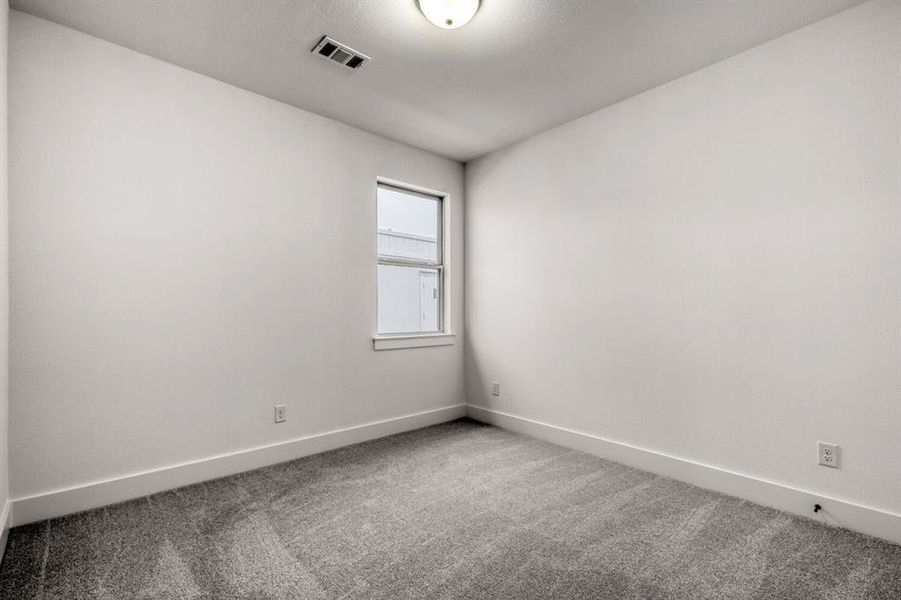 Spare room with baseboards and light carpet