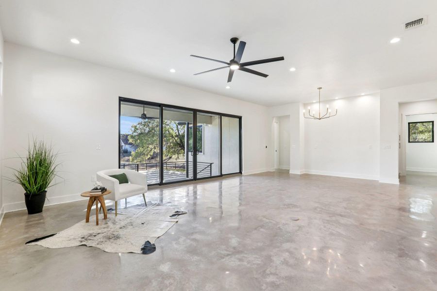 Designed for gathering, the open-concept living area features polished concrete floors and sweeping lake views.