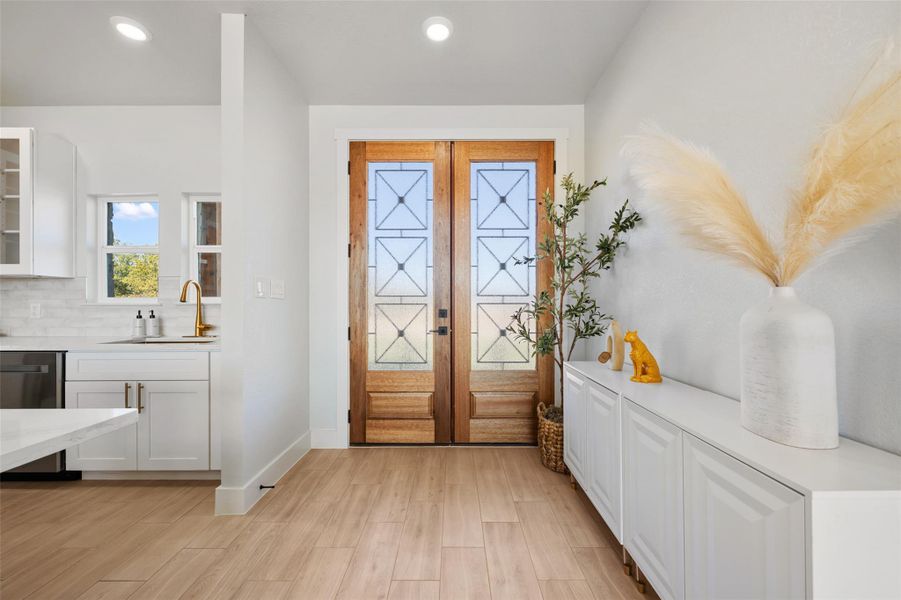 Entryway featuring recessed lighting, wood finished floors, and french doors